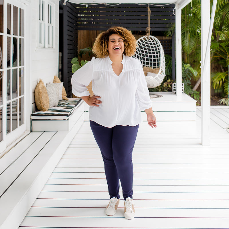 wearing our white Felicity billow sleeve blouse with our Suzie ponte joggers in navy. 