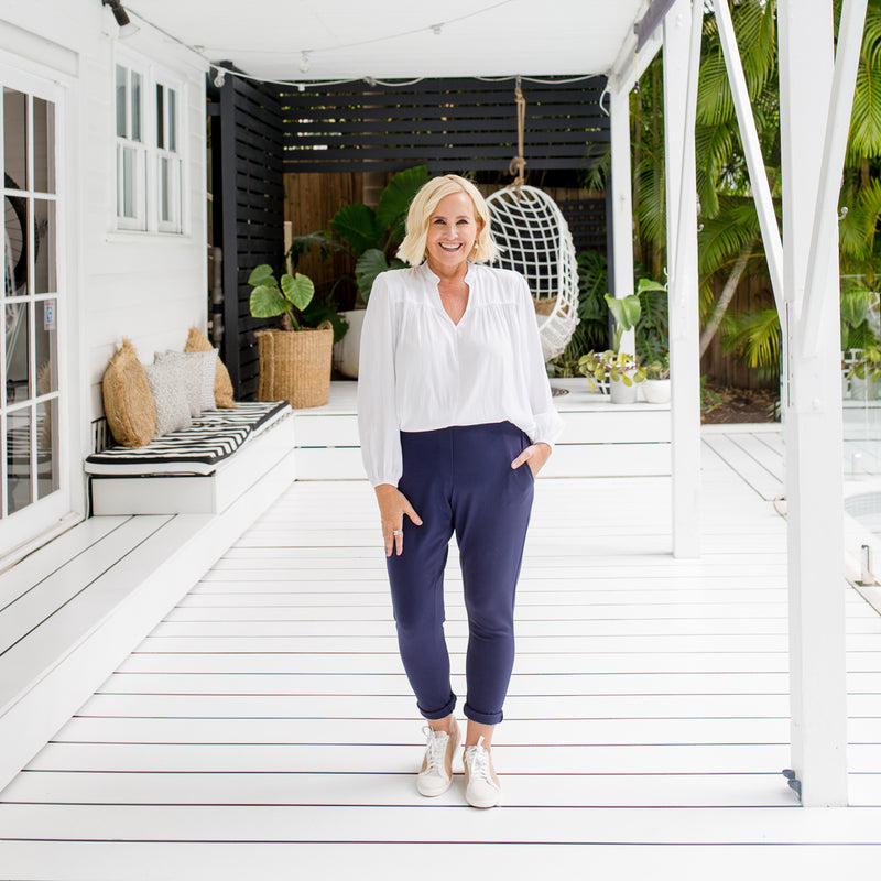 wearing our white Felicity billow sleeve blouse with our Suzie ponte pants in navy.
