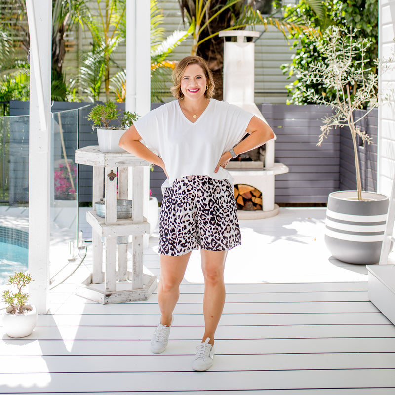 Bec wearing our white Alexa tee with our Gillian animal print shorts and white sneakers.