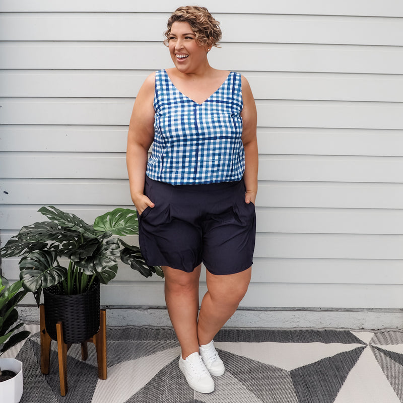 Jo in our Alexa Cami Gingham and our Bec technical shorts in Navy, paired with white sneakers