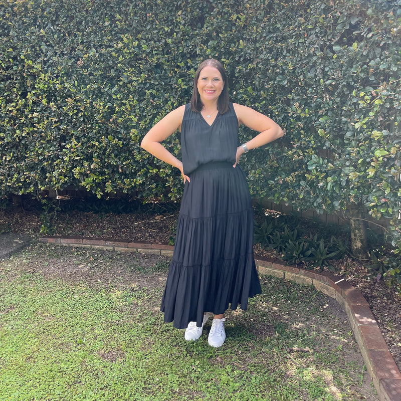 Our model Bec is wearing size 8 in our sophie technical tiered maxi skirt - black alongside with our stevie technical sleeveless blouse -black, paired with white sneakers.