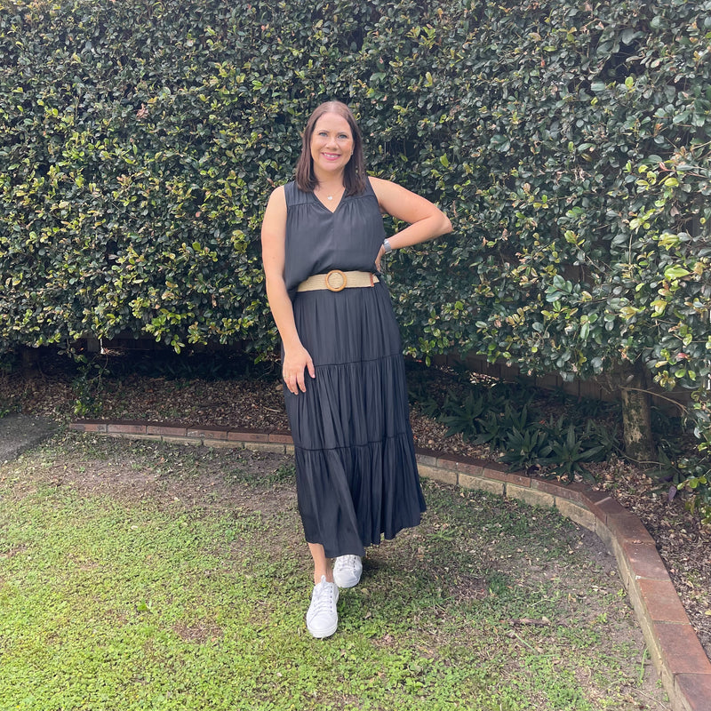 Our model Bec is wearing size 8 in our sophie technical tiered maxi skirt - black alongside with our stevie technical sleeveless blouse -black, paired with white sneakers and a light brown woven belt.