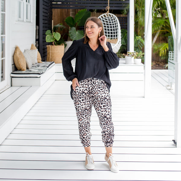 wearing our Felicity billow sleeve blouse in black with our Leanne animal print joggy pants. 