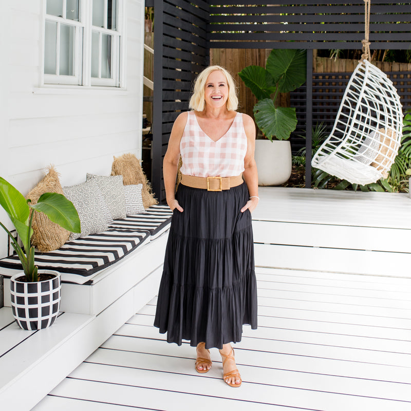 Nikki is wearing our Violet cami peach check tucked into Sophie maxi skirt in black with tan belt and sandals